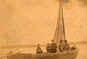 Five men on small boat from Selections from Special Collections and Archives